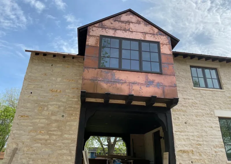 Copper metal panel facade on a stone building for Metal Roof Coating in West Bountiful